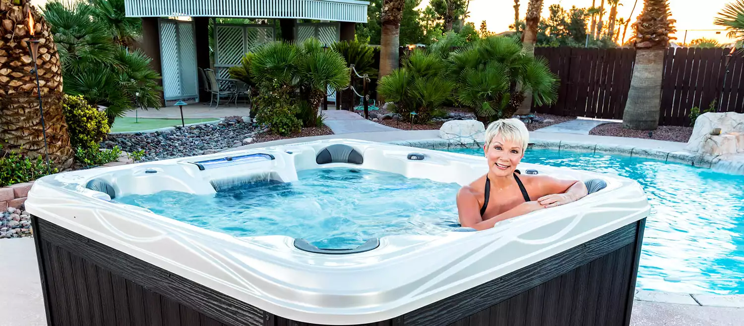 Artesian Spas Island Elite Grand Cayman Elite hot tub on a deck at dusk